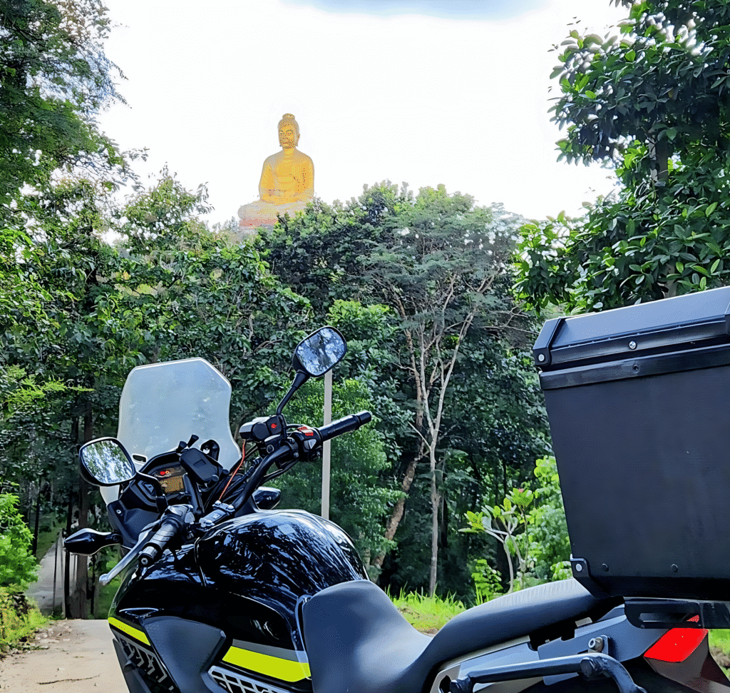 buddha statue on hill behind honda cb500x nothern thailand motorcycle trip